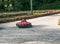 Karting. Go Kart on the track. Young positive racers in helmets driving a kart during a car race on an outdoor auto track. Extreme