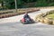Karting. Go Kart on the track. Young positive racers in helmets driving a kart during a car race on an outdoor auto track. Extreme