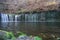 Karuizawa Shiraito waterfalls peaceful natural area featuring a small arc-shaped waterfall framed by mountain slopes