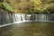 Karuizawa Shiraito waterfalls peaceful natural area featuring a small arc-shaped waterfall framed by mountain slopes in Novermber