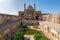 Kashan,Iran-04.08.2019: Courtyard, dome and minarets of Agha Bozorg Mosque in Kashan. Small garden in the middle of the