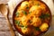 Kashmiri dum aloo: spicy potato with sauce closeup on the plate.