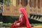Kashmiri woman in traditional red dress and ornaments