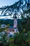 Kastelruth, Italy - 28 June 2018: The church of St. Valentin in Kastelruth/Castelrotto in the background the jagged rocks of the