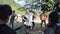 Kathmandu, Nepal - 27 November 2019: A young caucasian volunteer dancing, playing outdoors with Nepalese children