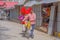 KATHMANDU, NEPAL OCTOBER 10, 2017: Unidentified man walking with a bike in the street with artificial plastic flowers in