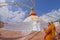 KATHMANDU, NEPAL OCTOBER 15, 2017: Close up of moks praying close the gorgeous monument Boudhanath stupa and its