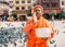 Kathmandu, Nepal - October 20, 2019: Portrait of orange dressed Sadhu old man posing to camera on Boudhanath Bouddha Stupa