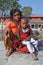 Kathmandu, Nepal, October, 27, 2012, Nepali Scene: the poor woman with a child begging in ancient Pashupatinath complex on the ba