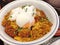 Katsu-don with Onsen tamago, a bowl of rice topped with a deep-fried pork cutlet, egg and vegetables