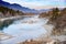 The Katun river in mountainous Altai, with rocky shores, mountainous autumn taiga with blue sky and clouds in the evening light