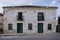 Kavarna, Bulgaria - September 2nd 2016: Stone facade of a medieval house, green doors, brown windows and a flat clay tile roof