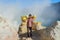 Kawa Ijen Volcano, Banyuwangi, Java Island, Indonesia - 09/09/ 2019: Indonesian sulfur miner is carrying sulfur from the floor of