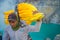 KAWEH IJEN, INDONESIA - 3 MARCH, 2017: Local miners carrying heavy loads of yellow sulfur rocks up mountain side
