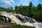 Kawishiwi Falls in Ely Minnesota USA With Cloudy Blue Sky