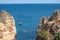 Kayak excursions to visit the caves to the cave of the tourist Praia do Camilo de Lagos in the Algarve, Portugal in the summer of