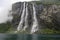 Kayak explorers at Seven Sisters waterfalls sourounded by mystic fog, Geiranger Fjord in Norway