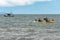 Kayak and fishing boat on the sea, in Paraty, Brazil