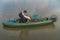 Kayak fishing. Fisherman caught pike fish on inflatable boat with fishing tackle at lake