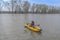 Kayak fishing at lake. Fisherwoman on inflateble boat with fishi