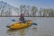 Kayak fishing at lake. Fisherwoman on inflateble boat with fishi