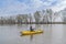 Kayak fishing at lake. Fisherwoman on inflateble boat with fishi