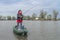 Kayak fishing at lake. Fisherwoman on inflateble boat with fishi
