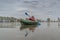 Kayak fishing at lake. Fisherwoman on inflateble boat with fishi