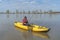 Kayak fishing at lake. Fisherwoman with pike fish on inflatable boat with fishing tackle