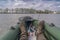 Kayak fishing at lake. Legs of fisherman on inflatable boat with fishing tackle