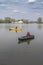 Kayak fishing at lake. Two fisherwomen on inflatable boats with fishing tackle