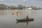 Kayak fishing at lake. Two fisherwomen on inflatable boats with fishing tackle