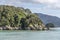 Kayak flotilla sailing at Kaka Point rocky cape near Kaiteriteri, Abel Tasman park,  New Zealand