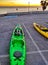 Kayak on the ground by the sea at sunrise. Kayaking sports in mornings. Two kayaks ready to go in Spain