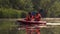 Kayak with a guy and a girl swims on the river. Slow motion