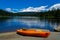 Kayak lying on the ground at Trillium Lake with the Mt. Hood in the background on a sunny day of early summer. Recreation and fish