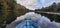 Kayak on mirror Lake on a classic day with both shores reflecting in the tranquil water