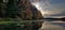 Kayak on mirror Lake sunset at a pier with fall colors reflecting