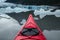 Kayak moving through icebergs in alpine lake of Alaska