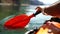 Kayak paddle sea vacation. Person paddles with orange paddle oar on kayak in sea. Leisure active lifestyle recreation
