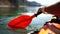 Kayak paddle sea vacation. Person paddles with orange paddle oar on kayak in sea. Leisure active lifestyle recreation