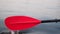 Kayak paddle water drops.Red paddle close-up.