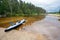 Kayak on the river in cloudy weather. The forest and the storm clouds