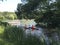 Kayak rowing. Children in lifejackets sail by canoe along the canal in the park.