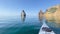In kayak sportsman, kayakers rowing at calm clear blue sea on calm summer day with no waves against the backdrop of