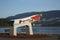 kayak statue public art with bridge, sea and mountain in background