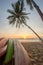 kayak under a palm tree on sand beach