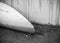 Kayak from white fiberglass plastic with aged marks
