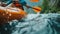 A kayaker braving the rough current of a rushing river navigating way through powerful rapids and rugged terrain. The