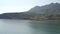 Kayaker floating along shore. Sea view. Amazing mountain range and strip beach